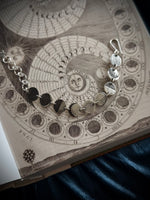Bracelet with celestial design on an open book